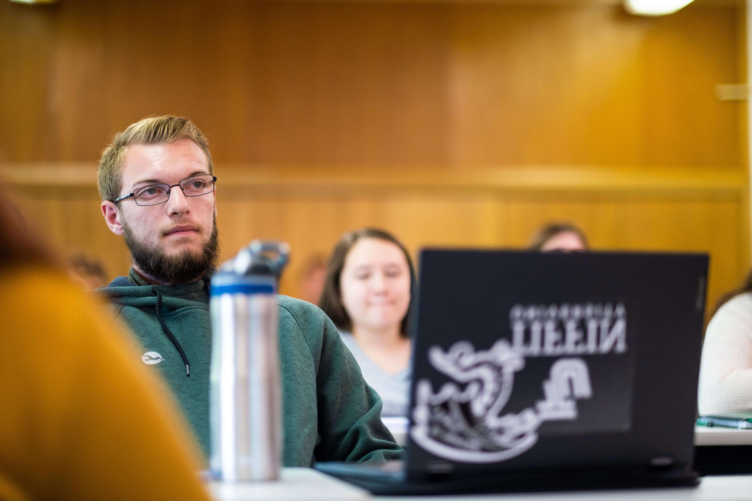 college student in class with laptop